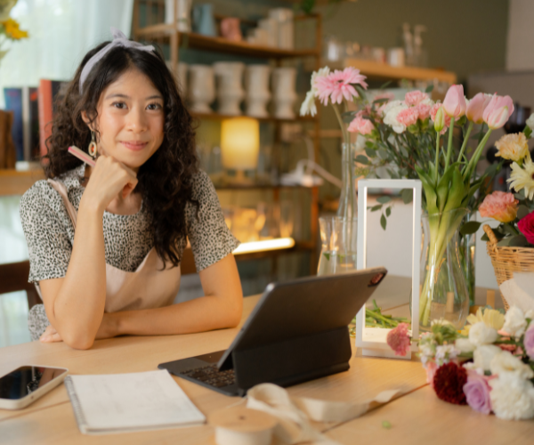 woman-owned business female business owner at desk reviewing finances