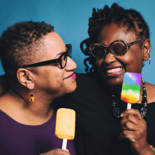 middle-age black lesbian couple eating popsicles